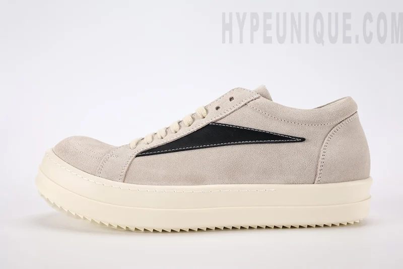 The Rick Owens Low-Top Sneakers ‘Beige’ showcase a minimalist yet distinctive design, true to the designer’s avant-garde aesthetic. Crafted from premium beige leather, they feature elongated laces and a chunky rubber sole that adds a bold touch. The neutral color palette ensures versatility with various outfits, while high-quality materials offer comfort and durability. Ideal for those seeking a blend of edgy style and everyday functionality in their footwear. hypeuunique