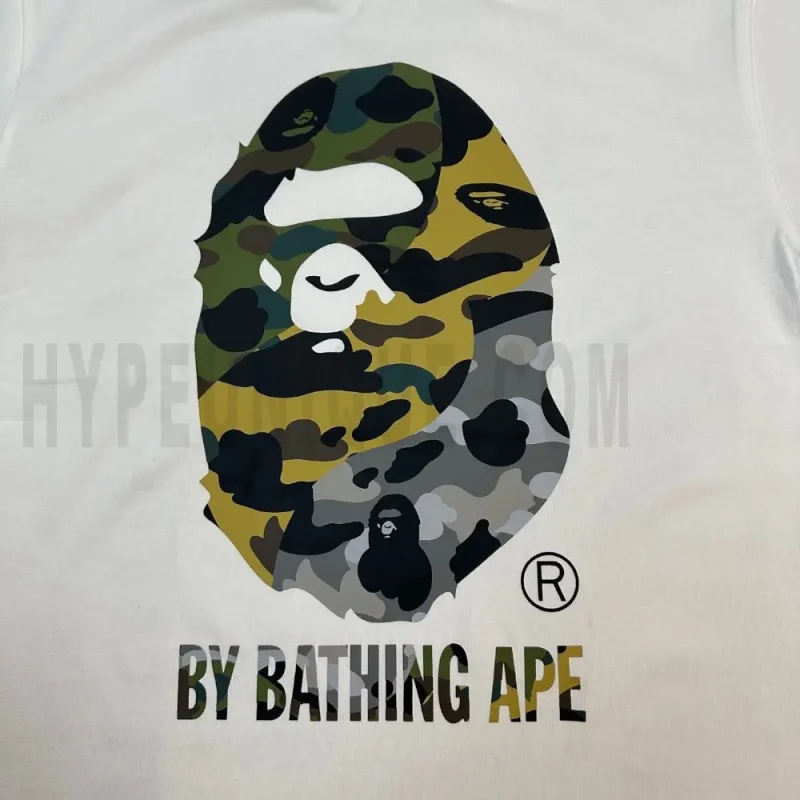 Detailed shot capturing the graphic print on the white tee's front panel.