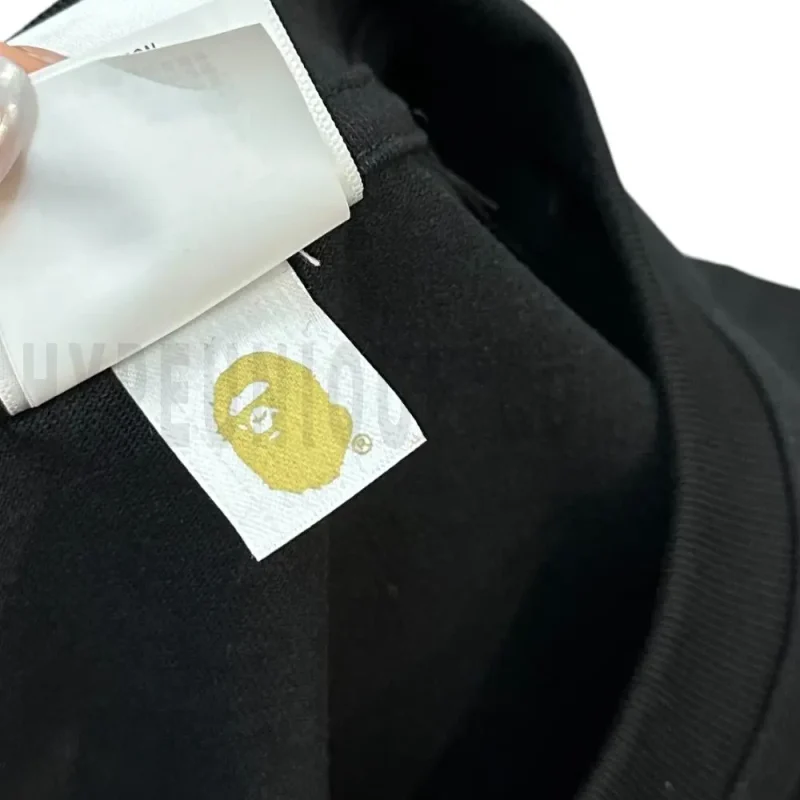 Neckline tag close-up, displaying garment care symbols and brand information with fashion-forward presentation.