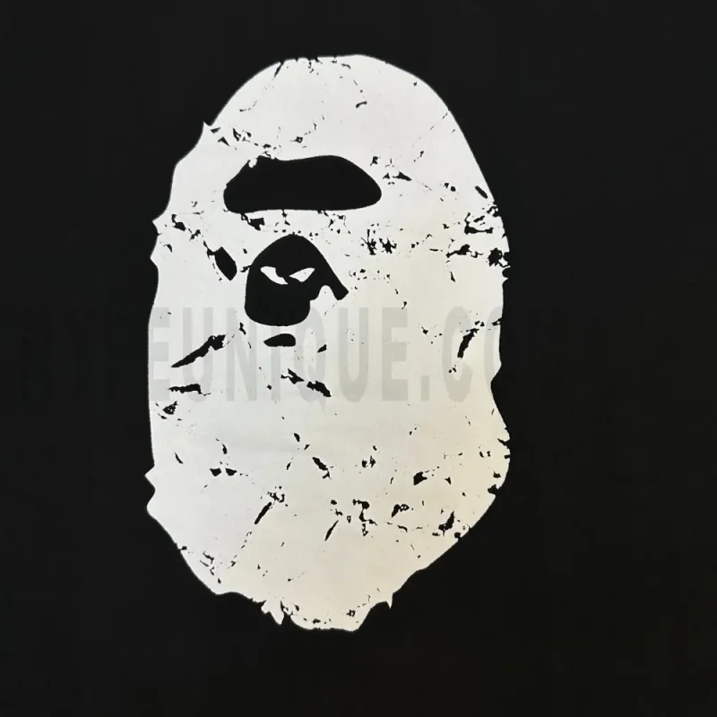 Detailed shot capturing the graphic print on the black tee's front panel.