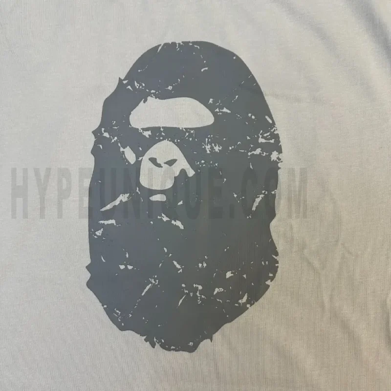 Detailed shot capturing the graphic print on the white tee's front panel.