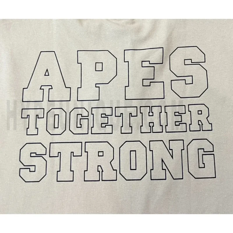 Detailed shot capturing the graphic print on the beige tee's back panel.