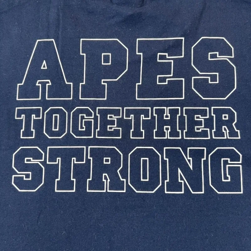 Detailed shot capturing the graphic print on the blue tee's back panel.