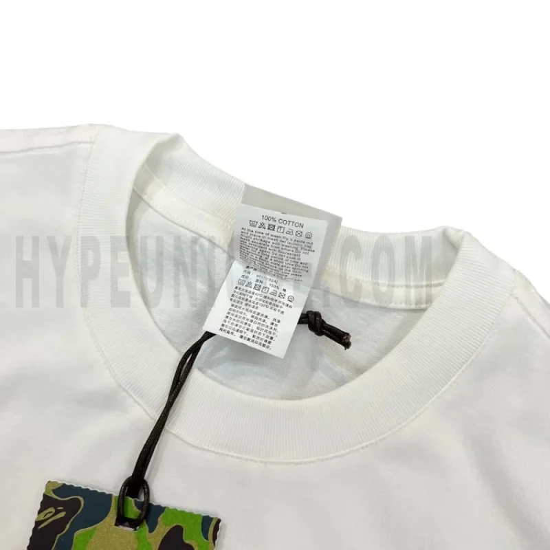 Neckline tag close-up, displaying garment care symbols and brand information with fashion-forward presentation.