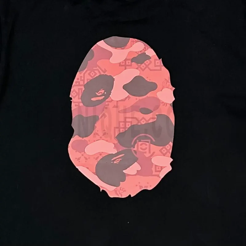 Detailed shot capturing the graphic print on the black tee's back panel.