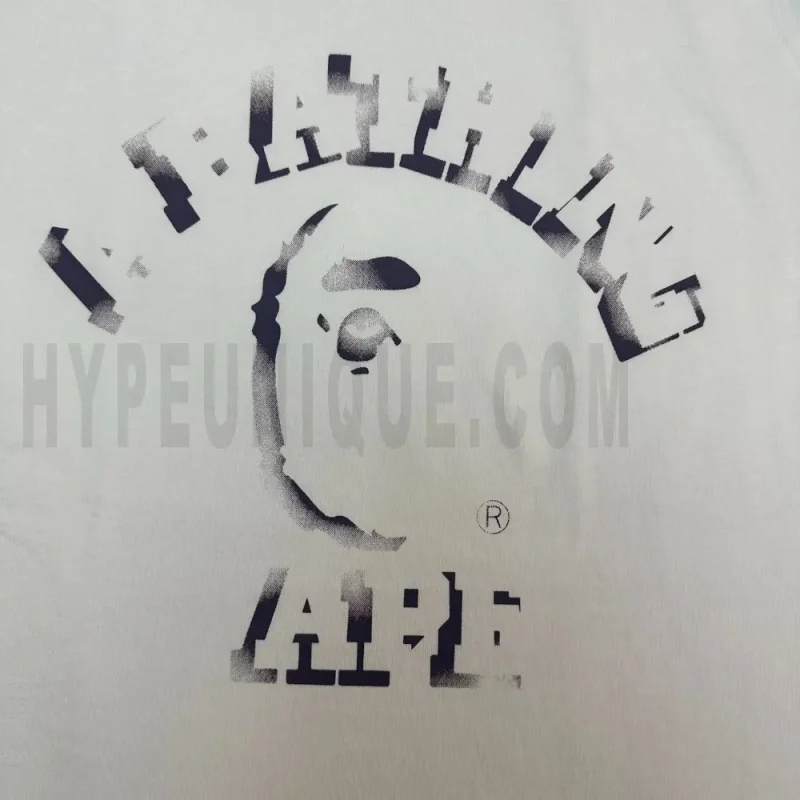 Detailed shot capturing the graphic print on the white tee's front panel.