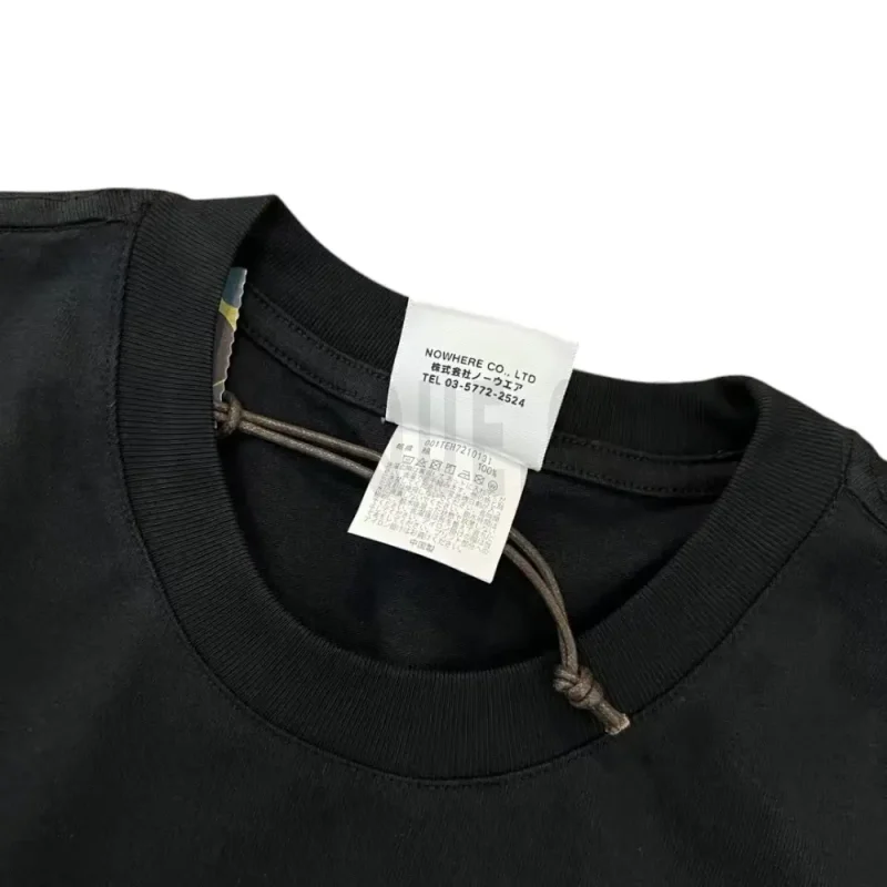 Neckline tag close-up, displaying garment care symbols and brand information with fashion-forward presentation.