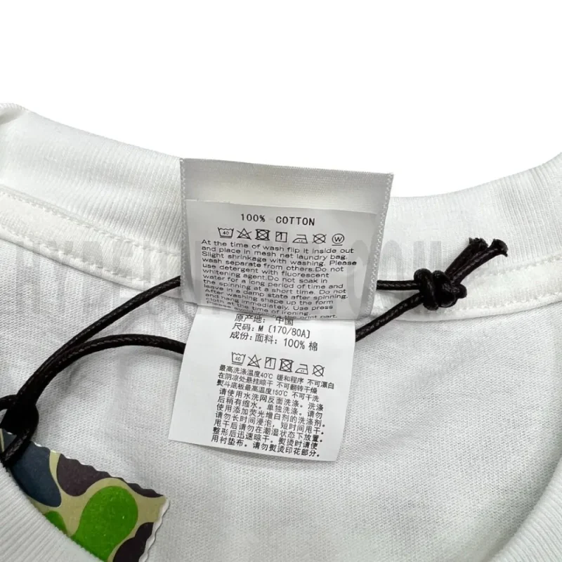 Close-up detail of the neck tag, showcasing care instruction icons and elevated brand labeling—designed with a contemporary aesthetic edge.
