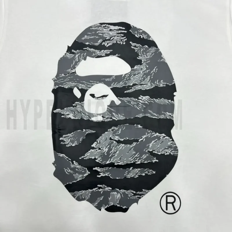 Detailed shot capturing the graphic print on the white tee's front panel.