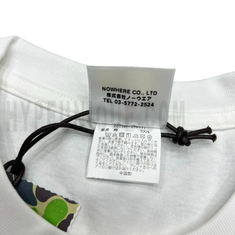 Close-up detail of the neck tag, showcasing care instruction icons and elevated brand labeling—designed with a contemporary aesthetic edge.
