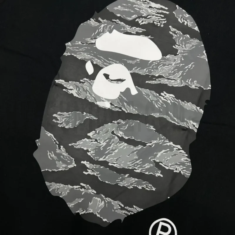 Detailed shot capturing the graphic print on the black tee's front panel.