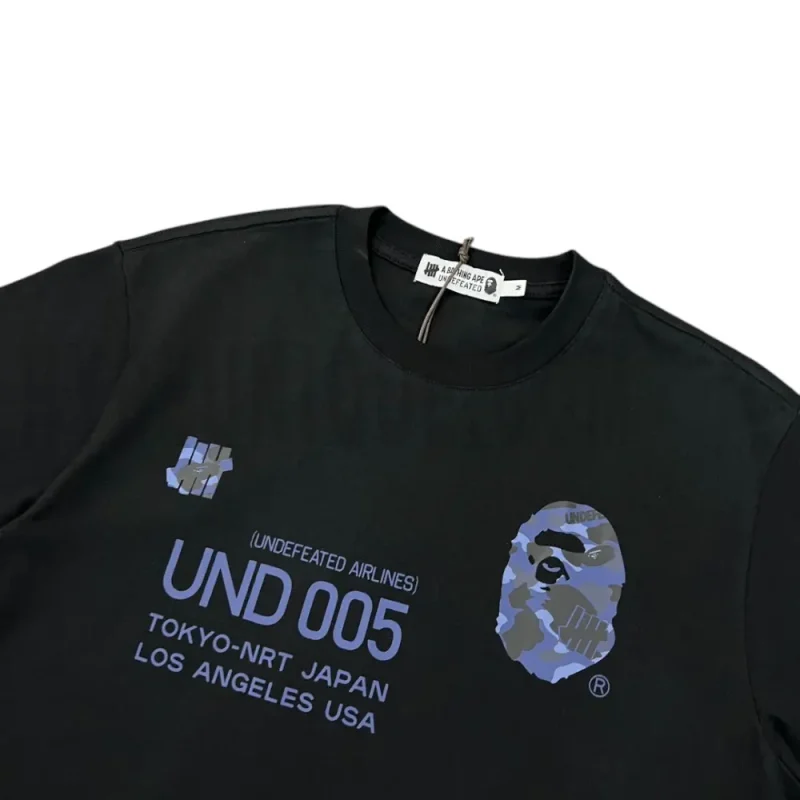 Detailed shot capturing the graphic print on the black tee's front panel.
