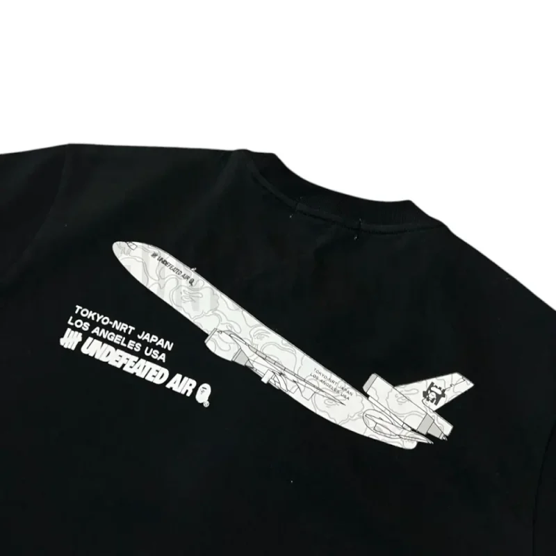 Detailed shot capturing the graphic print on the black tee's back panel.