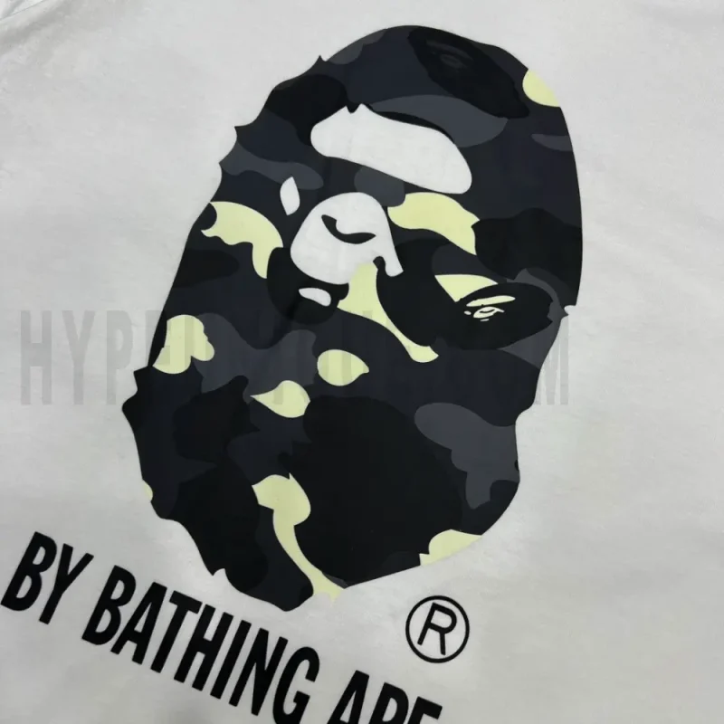 Detailed shot capturing the graphic print on the white tee's front panel.