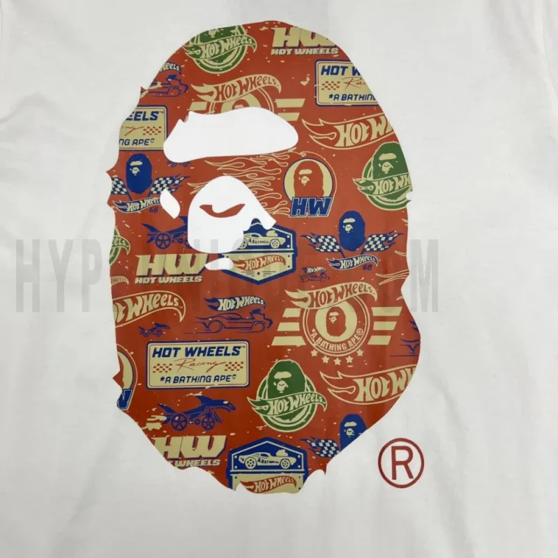 Detailed shot capturing the graphic print on the white tee's front panel.