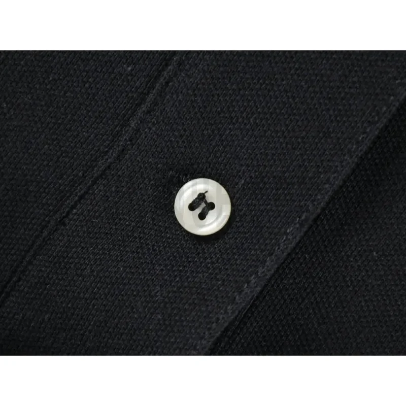 Close-up of button detail on the garment