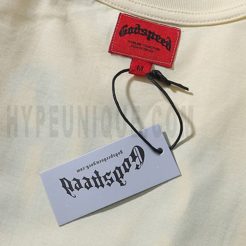 Close-up of the tee's featuring wash care instructions and subtle brand branding in a clean, minimalist typography