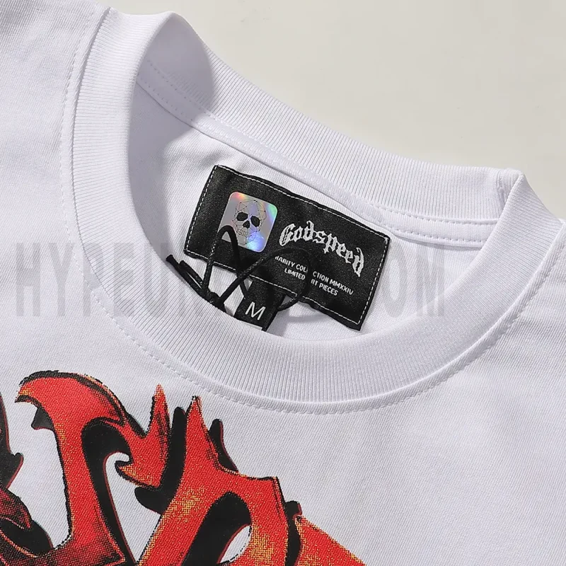 Detailed close-up of the tee's neck label, featuring wash care instructions and subtle brand branding in a clean, minimalist typography
