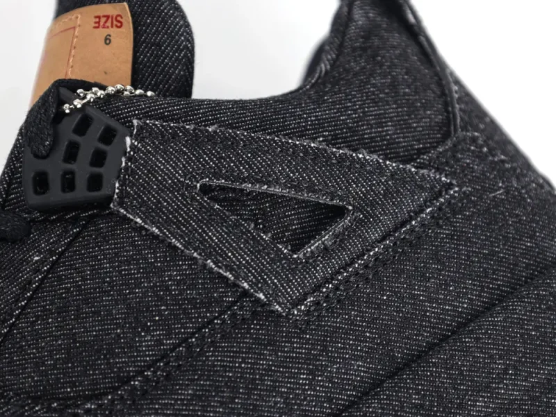 Rear view of the Air Jordan 4 Retro Levi’s Black GS, highlighting the brown Levi’s patch on the heel and the gum outsole details