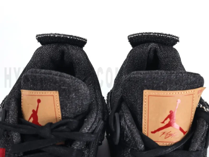 Air Jordan 4 Retro Levi’s Black GS displayed with box and accessories, featuring black denim upper, gum sole, and signature Levi’s branding.