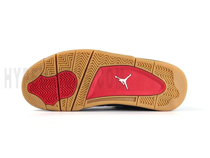 Outsole view of the Air Jordan 4 Retro Levi’s Black, featuring a gum rubber sole with red traction zones and a white Jumpman logo.
