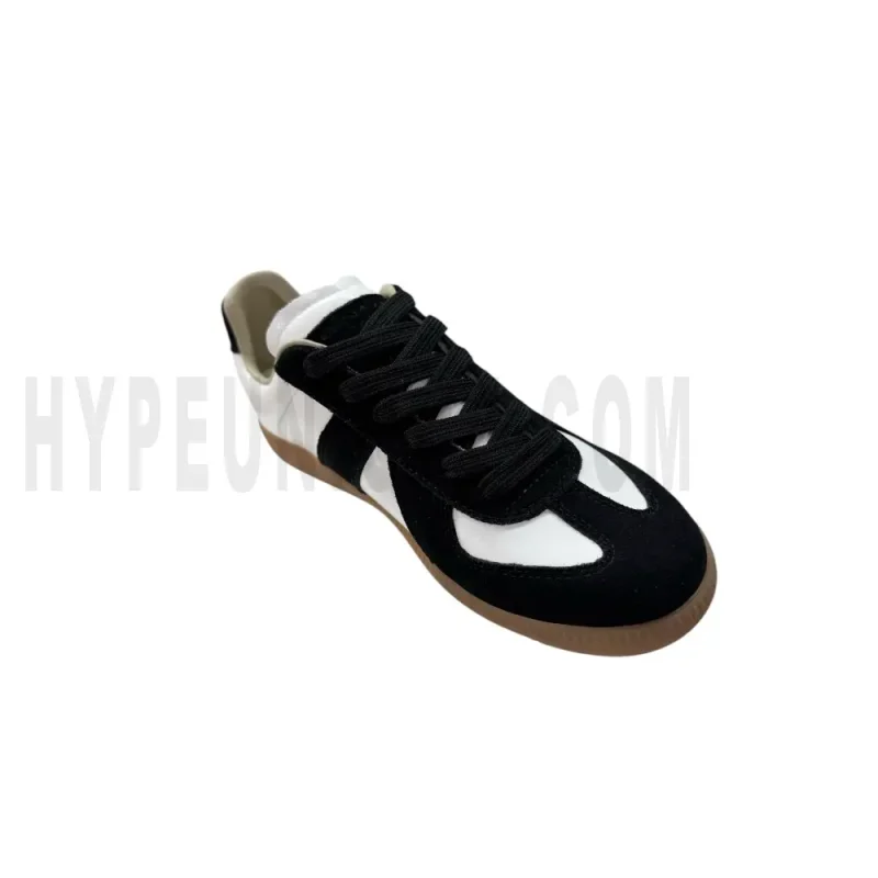 The left of the white and black shoes