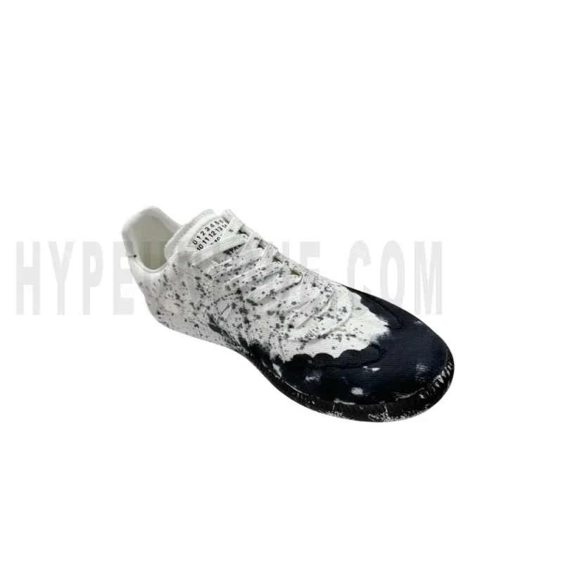 The left of the white shoes