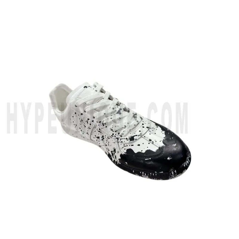 The left of the white shoes