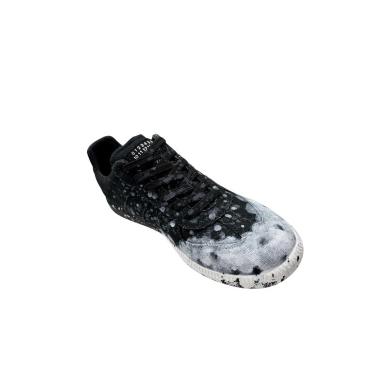 The left of the white shoes