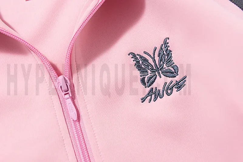 Close-up of butterfly embroidery detail on the chest of the jacket.