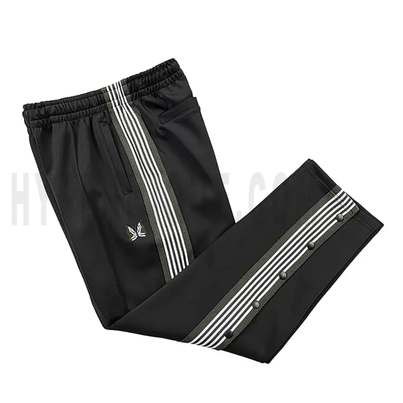 Side view of black track pants.