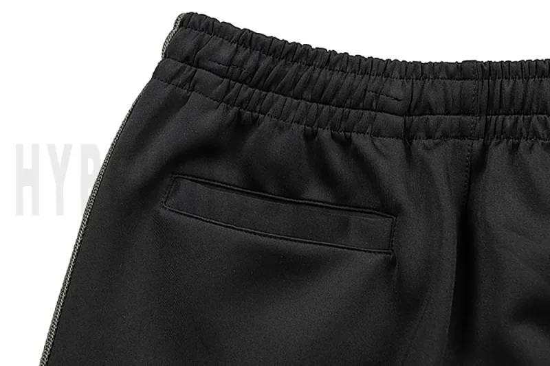 Detail of the back pocket on the track pants.