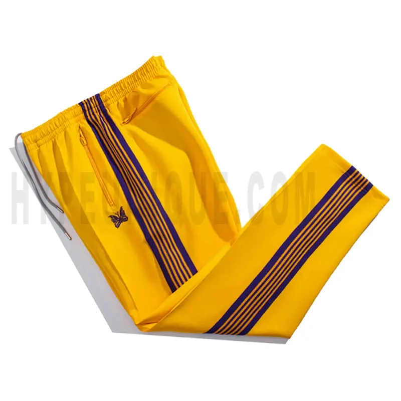 Side view of yellow track pants.