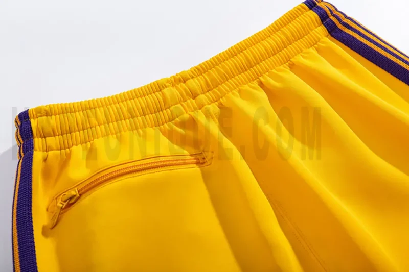 Detail of the back zip pocket on the track pants.
