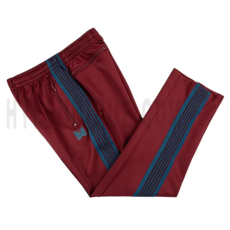 Side view of dark red track pants.