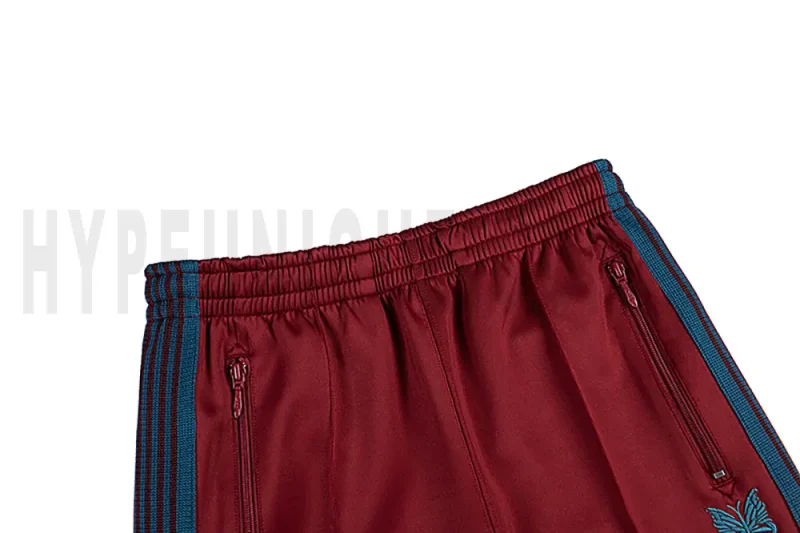 Detail of the back zip pocket on the track pants.
