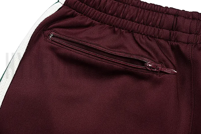 Detail of the back zip pocket on the track pants.
