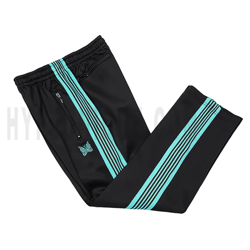 Side view of black track pants.