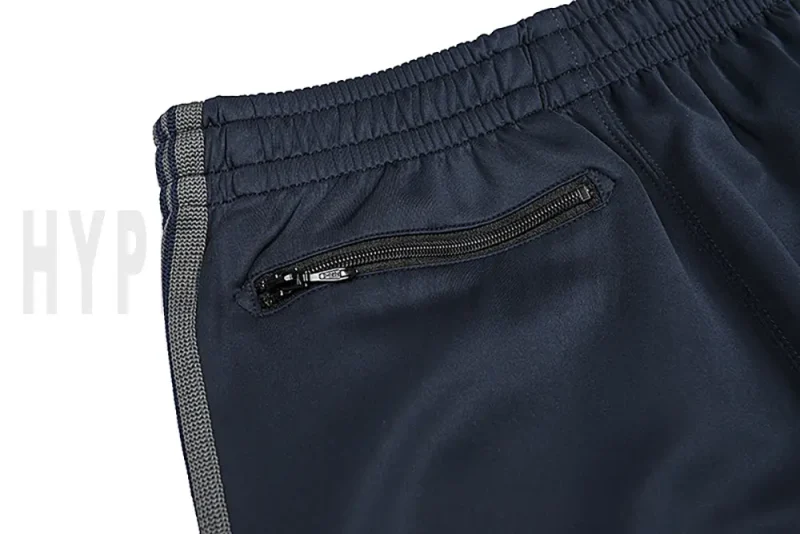 Detail of the back zip pocket on the track pants.