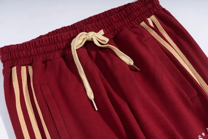Adjustable webbing belt at the waist for a customizable fit.