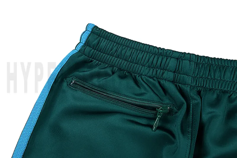 Detail of the back zip pocket on the track pants.