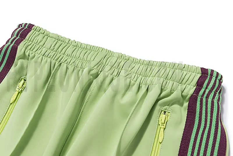 Close-up detail of the track pants pocket.