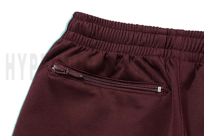 Detail of the back zip pocket on the track pants.