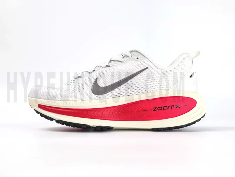 The left of the Nike Vomero 18 'Platinum Tint Siren Red' Road Running Shoes.
