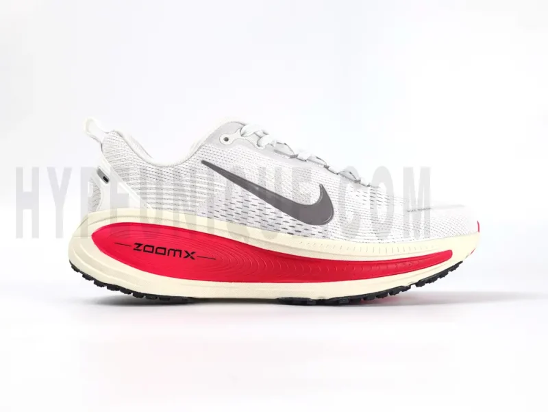 The right of the Nike Vomero 18 'Platinum Tint Siren Red' Road Running Shoes.