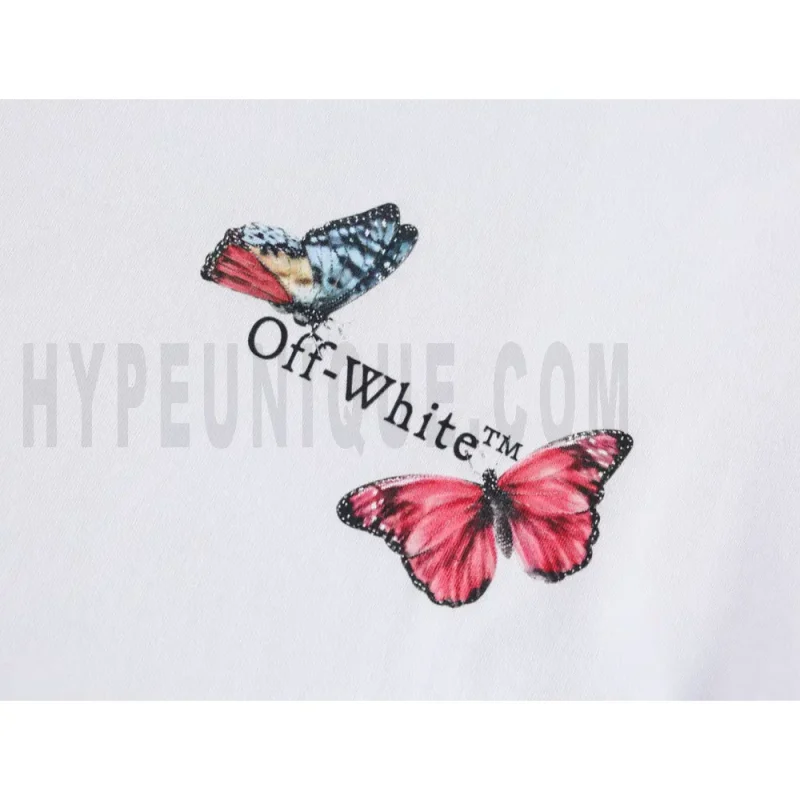 Detailed shot capturing the graphic print on the white tee's front panel.