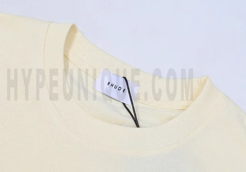 Close-up of the T-shirt's neckline tag, showcasing wash care instructions and brand details in a fashion design.