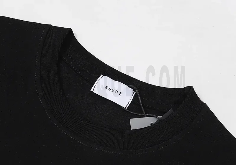 Close-up of the T-shirt's neckline tag, showcasing wash care instructions and brand details in a fashion design.