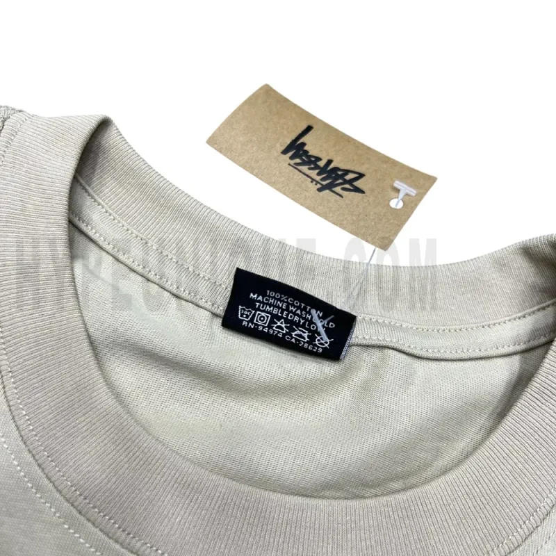 Neckline tag close-up, displaying garment care symbols and brand information with fashion-forward presentation.