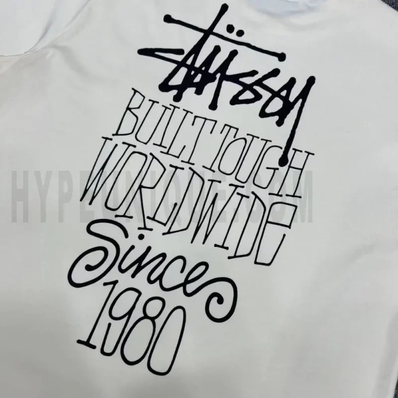 Detailed shot capturing the graphic print on the white tee's back panel.